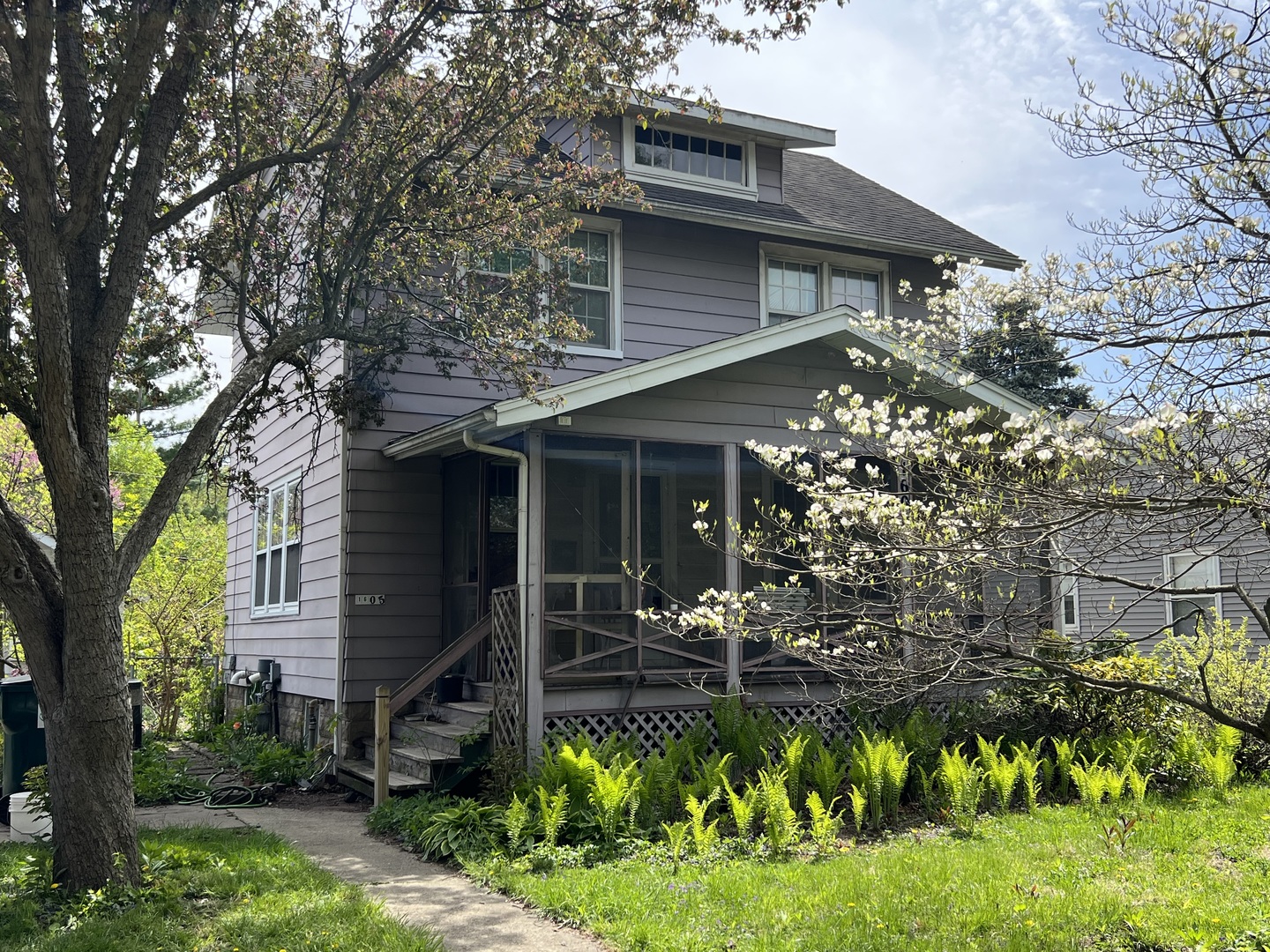 1605 West University Avenue Champaign, IL 61821 - Photo 1 of 8 a front view of a house with a yard