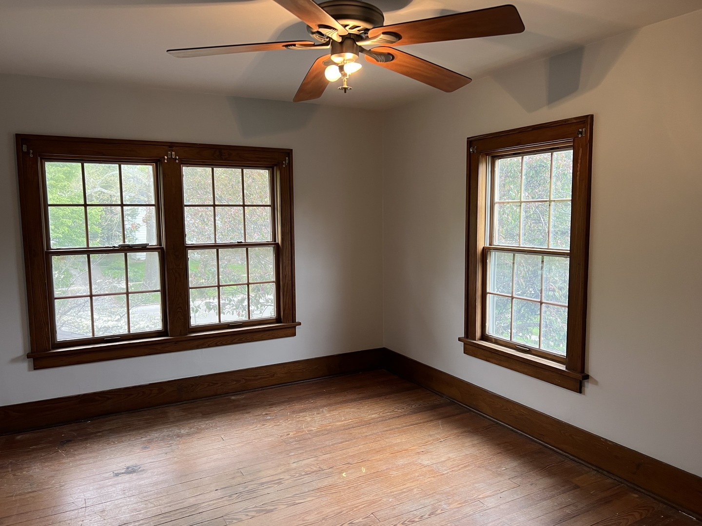 1605 West University Avenue Champaign, IL 61821 - Photo 5 of 8 an empty room with a window and ceiling fan