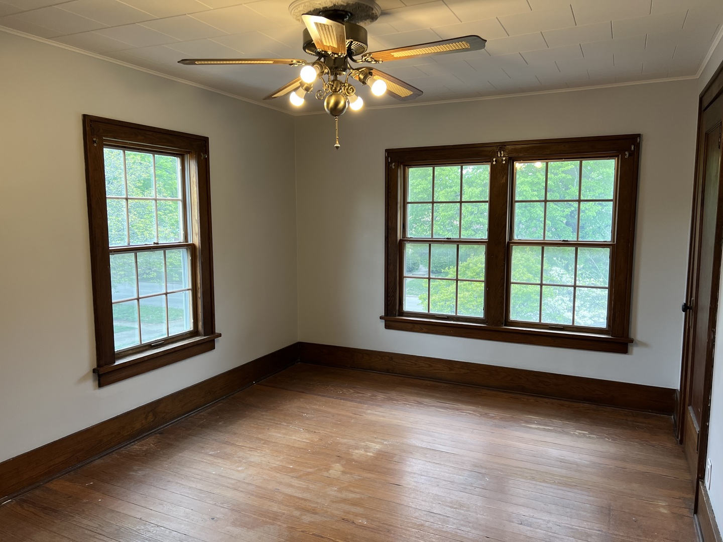 1605 West University Avenue Champaign, IL 61821 - Photo 6 of 8 a view of an empty room with chandelier fan and a window
