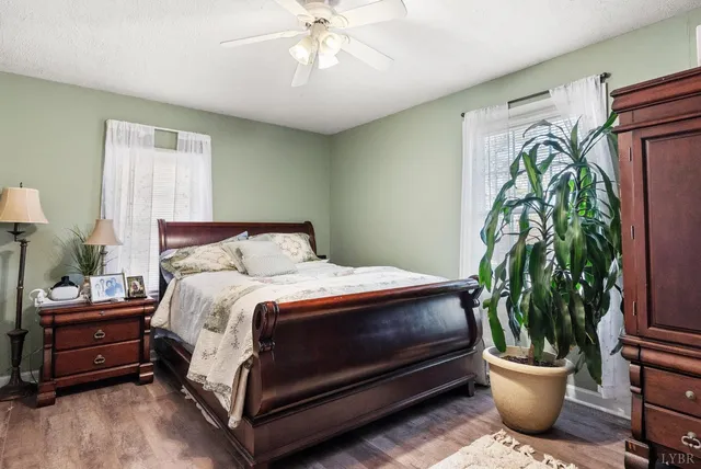 a bedroom with a bed table and a potted plant