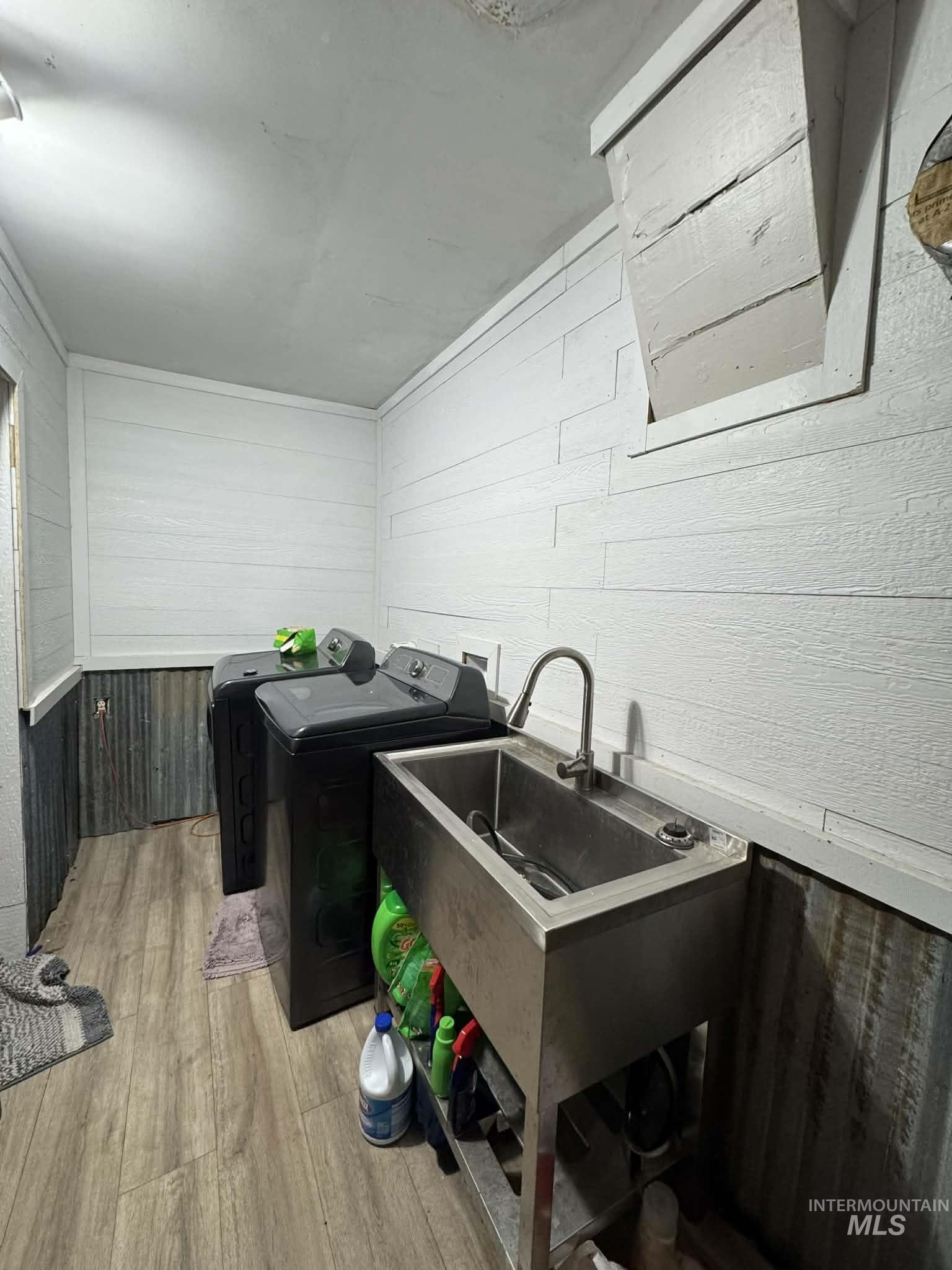 40238 Sr 129 Anatone, WA 99401 - Photo 11 of 13 Laundry area featuring wood walls, light wood finished floors, and washing machine and dryer