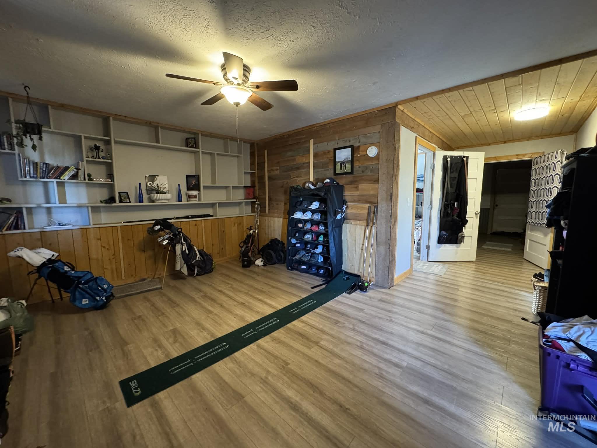 40238 Sr 129 Anatone, WA 99401 - Photo 4 of 13 Area featuring wood walls, wood finished floors, a textured ceiling, and ceiling fan