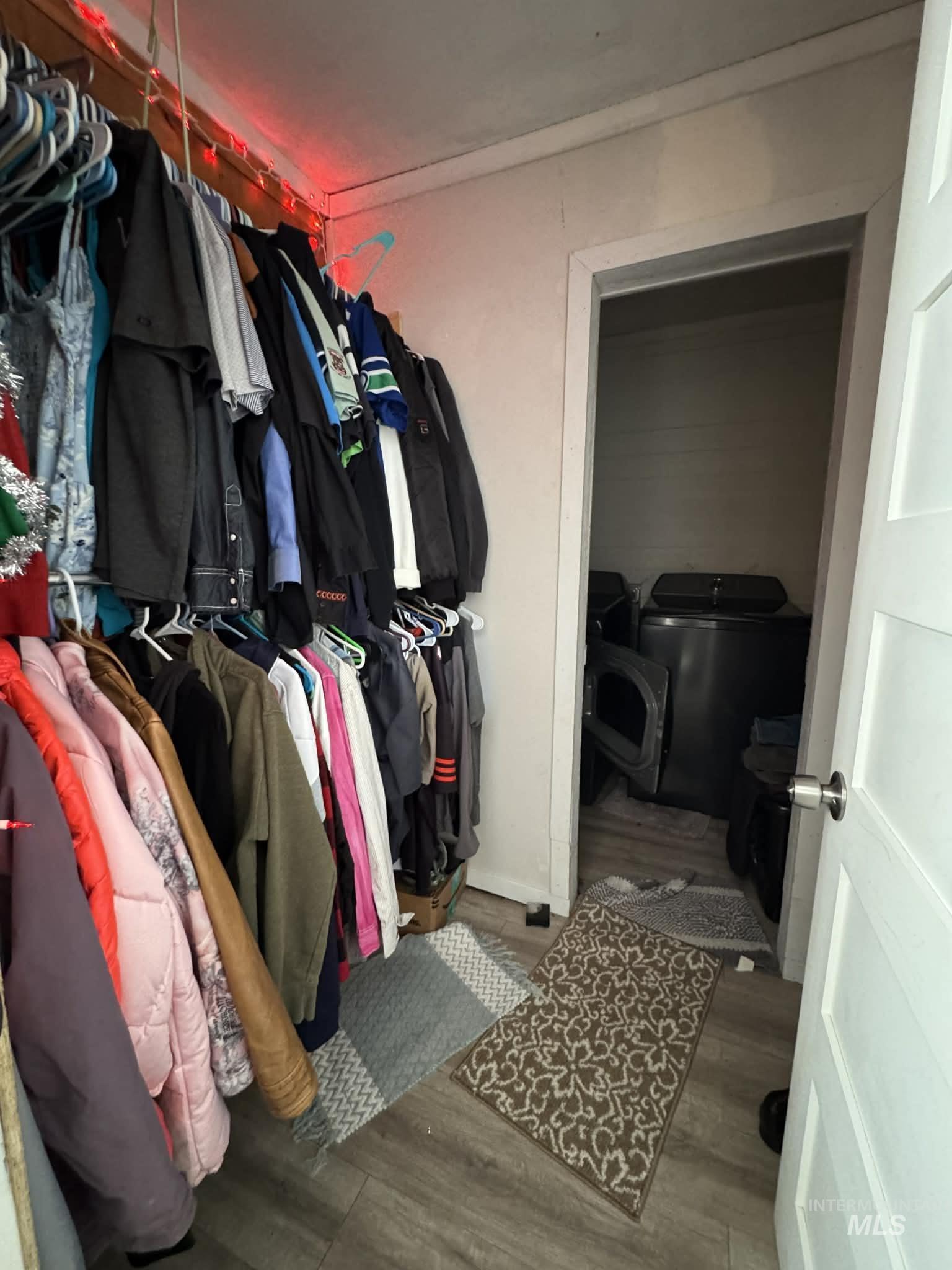 40238 Sr 129 Anatone, WA 99401 - Photo 6 of 13 Walk in closet with wood finished floors and washing machine and clothes dryer