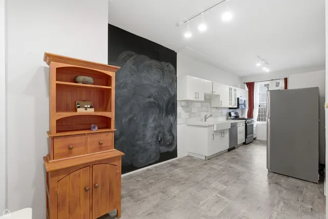 a kitchen with a refrigerator and a stove