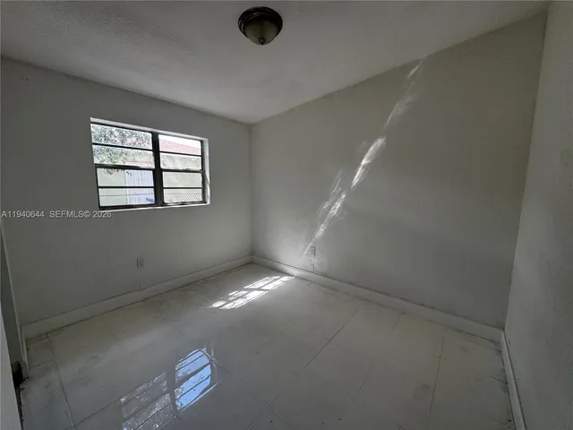 an empty room with a empty space and windows