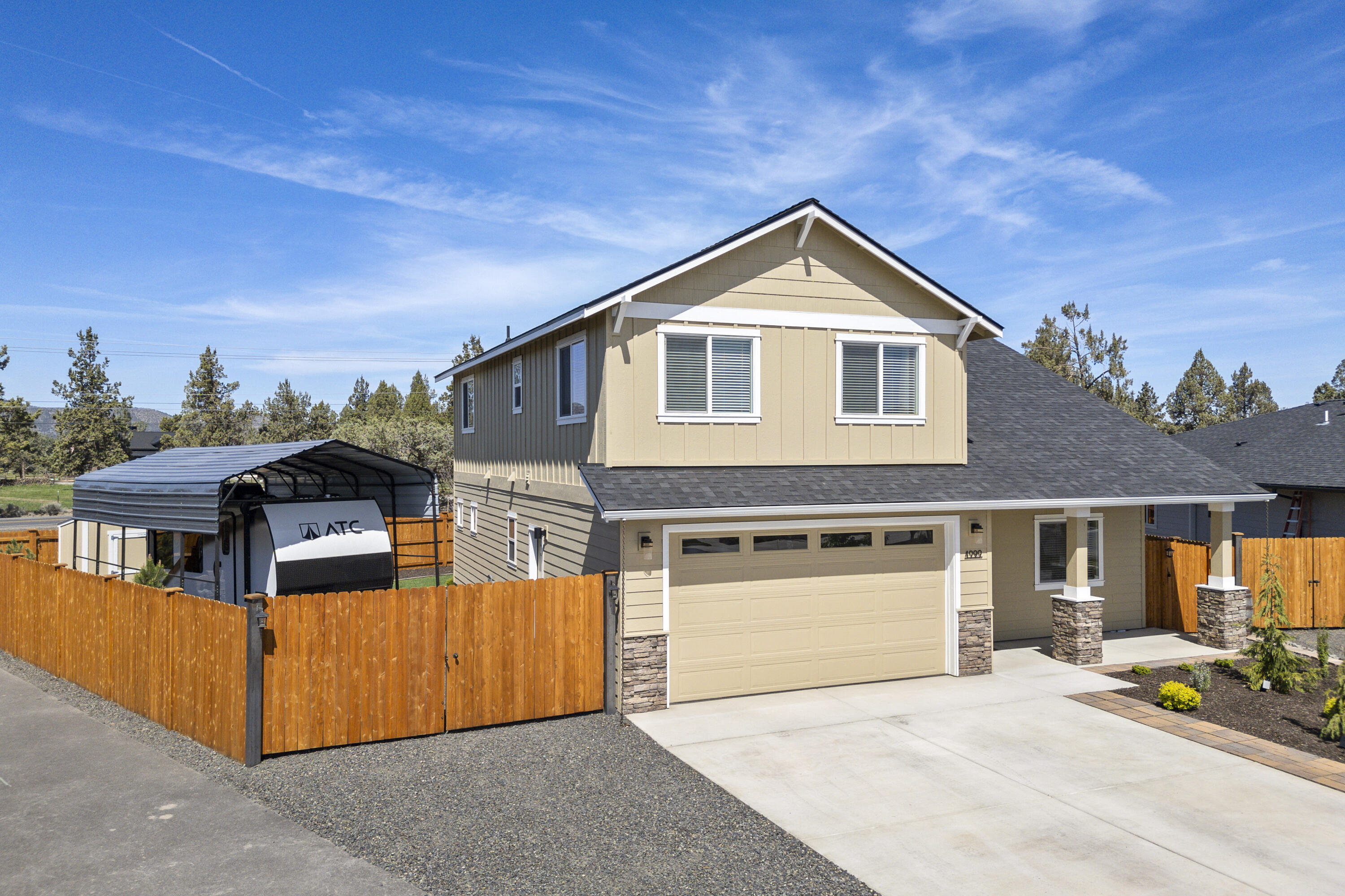 4999 Southwest Yew Place Redmond, OR 97756 - Photo 3 of 50 a front view of a house with a yard