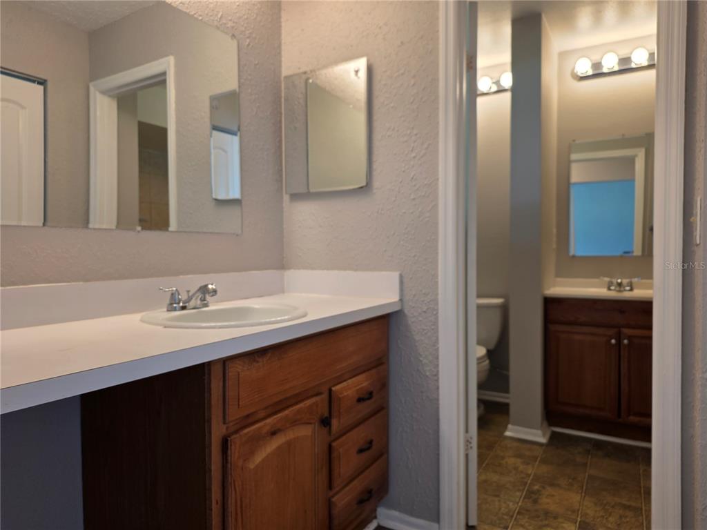 162 Olive Tree Circle Altamonte Springs, FL 32714 - Photo 45 of 47 a bathroom with a double vanity sink and mirror