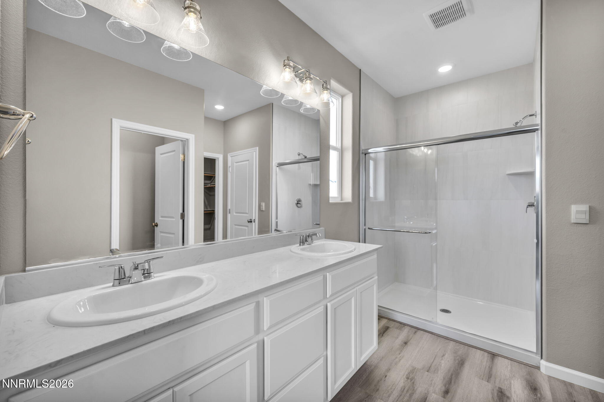 6668 Morgan Mill Road, Unit HOMESITE 15 Carson City, NV 89701 - Photo 15 of 25 a bathroom with a double vanity sink mirror and shower