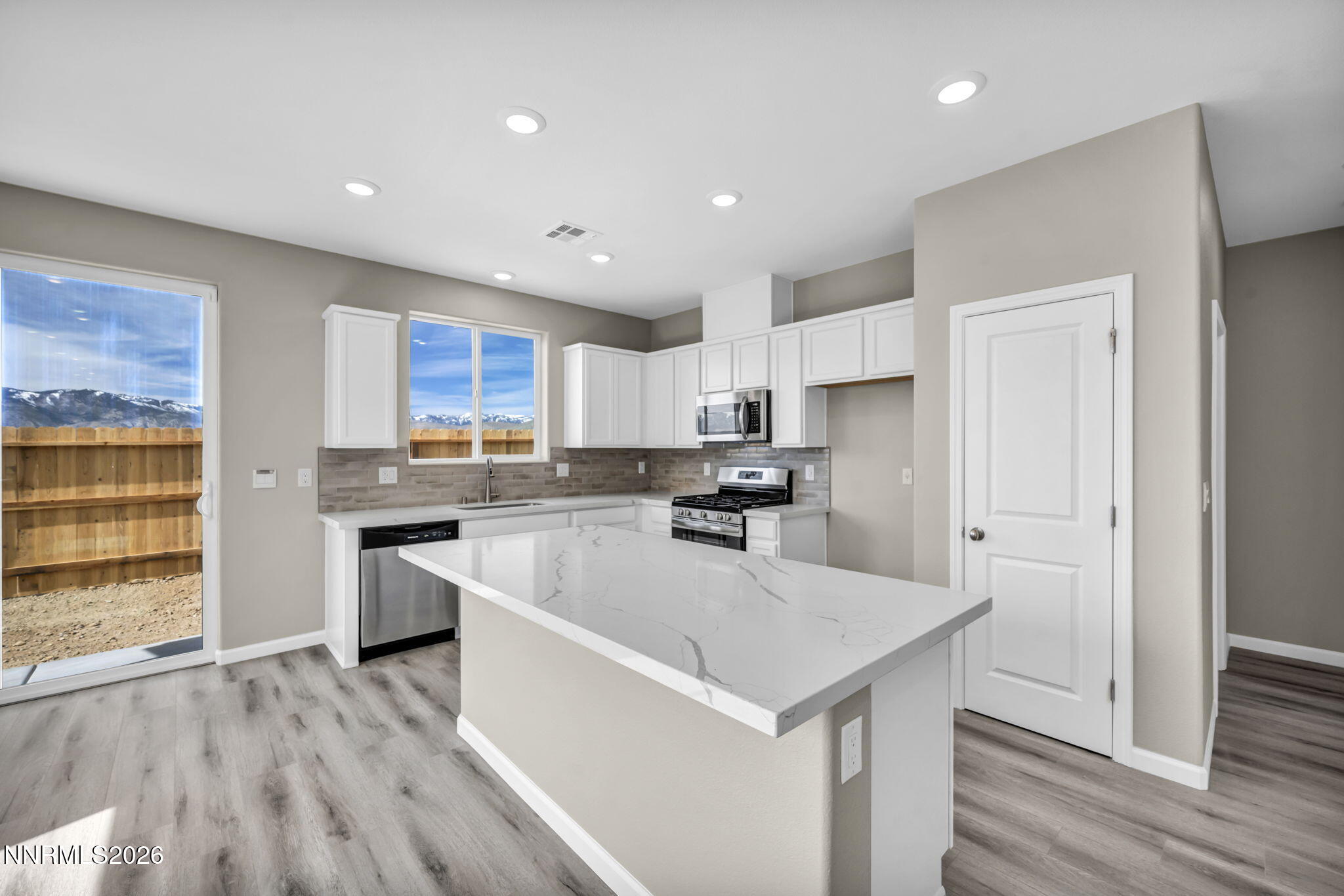6668 Morgan Mill Road, Unit HOMESITE 15 Carson City, NV 89701 - Photo 4 of 25 a kitchen with a sink a counter top space stainless steel appliances and cabinets