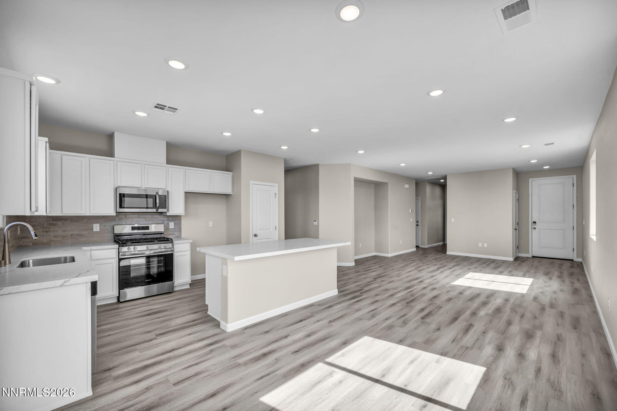 6668 Morgan Mill Road, Unit HOMESITE 15 Carson City, NV 89701 - Photo 5 of 25 a large kitchen with stainless steel appliances granite countertop a stove and a sink