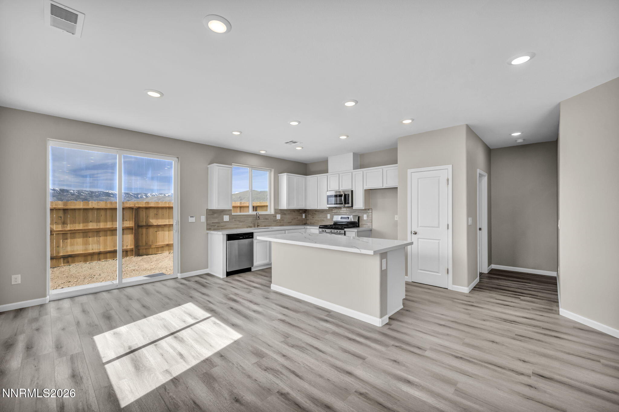 6668 Morgan Mill Road, Unit HOMESITE 15 Carson City, NV 89701 - Photo 6 of 25 a large kitchen with a large counter top a sink stainless steel appliances and cabinets