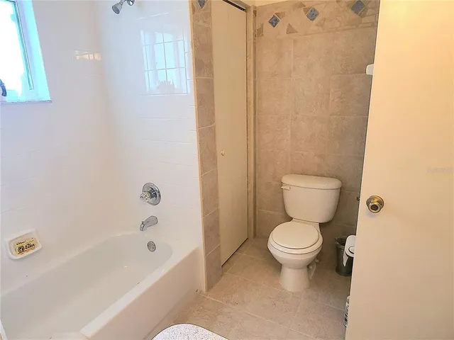 a bathroom with a toilet and a bathtub
