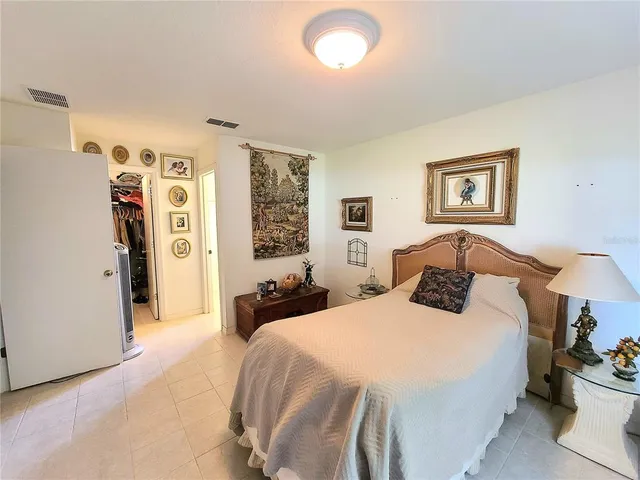 a bedroom with a bed and a large mirror