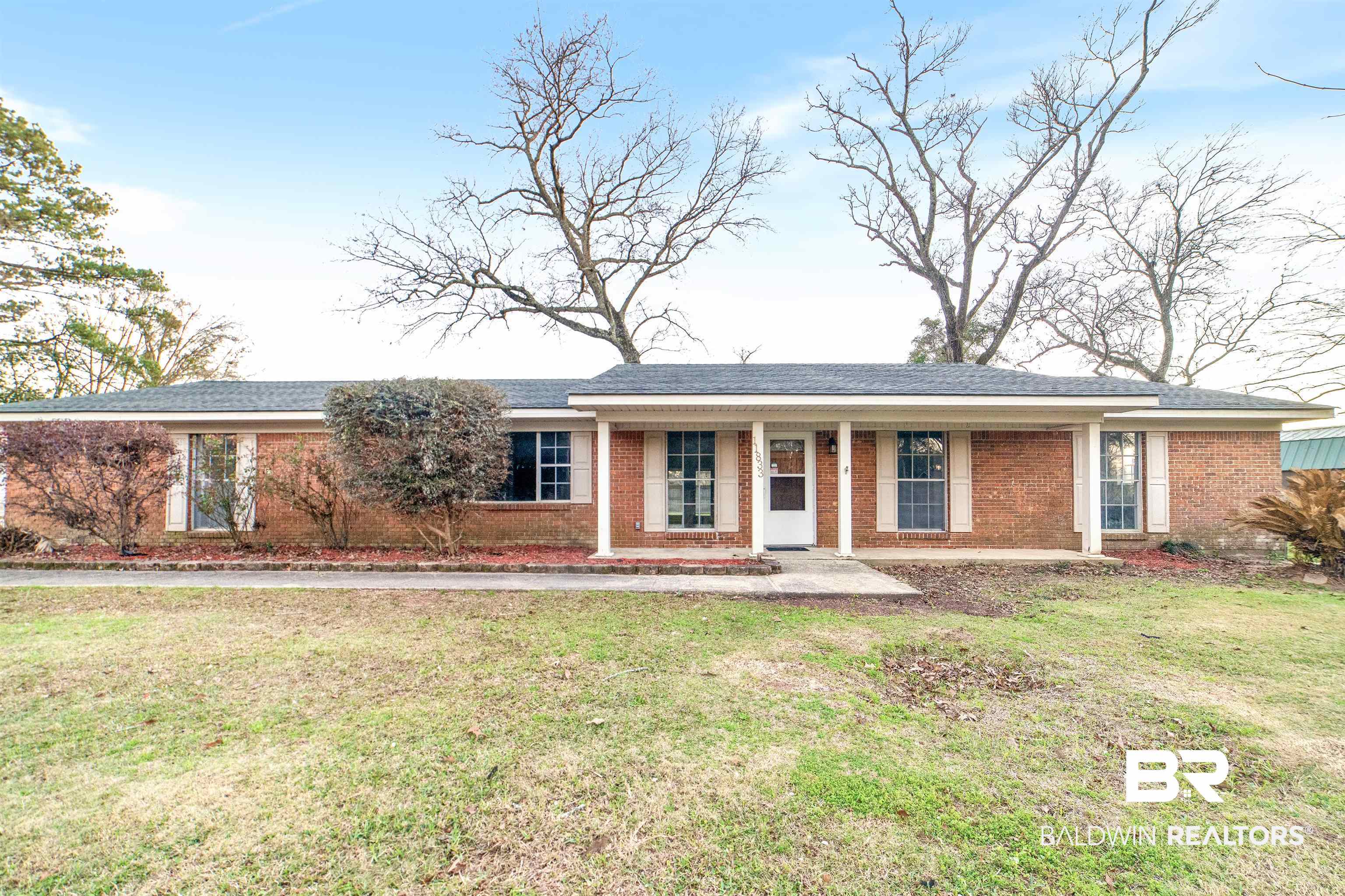 11833 Old Moffat Road Wilmer, AL 36587 - Photo 1 of 23 Single story home featuring covered porch, brick siding, and a front lawn