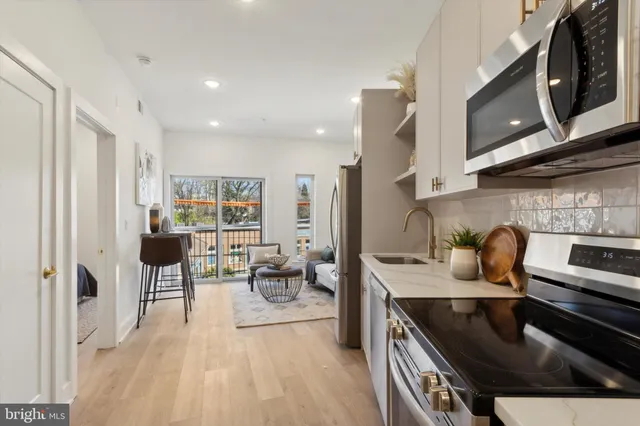 a kitchen with stainless steel appliances granite countertop a sink stove and cabinets