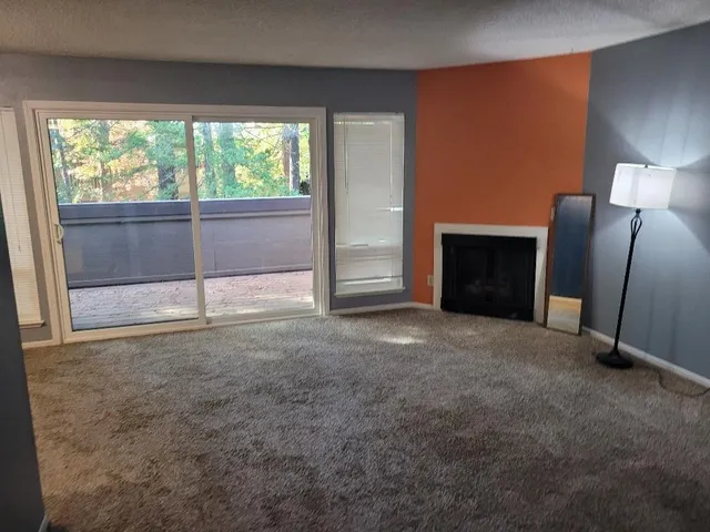 a view of an empty room with a fireplace