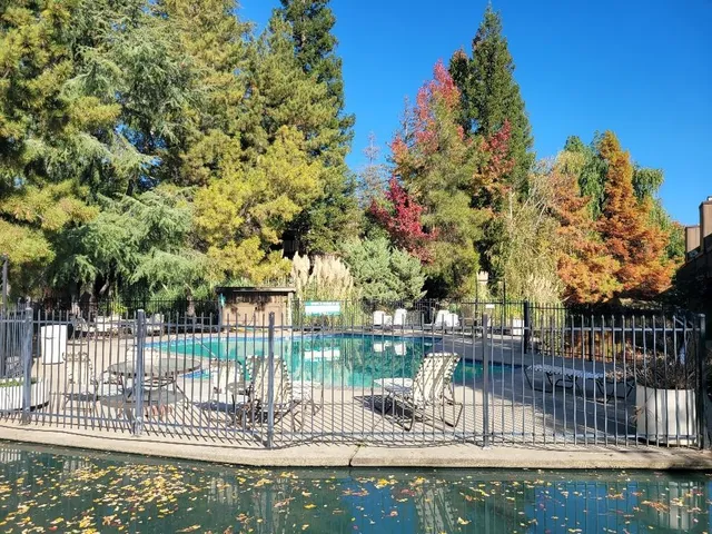 a view of a swimming pool with outdoor seating