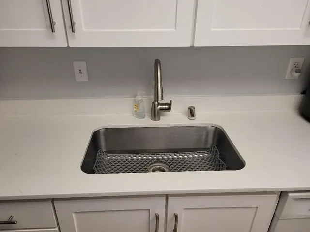 a kitchen with a sink and cabinets