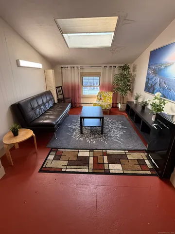 a living room with furniture and a rug