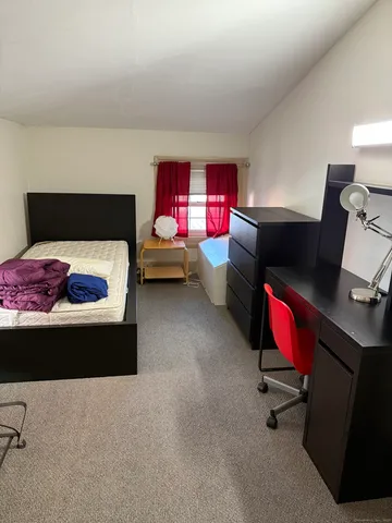 a bedroom with furniture and a bed