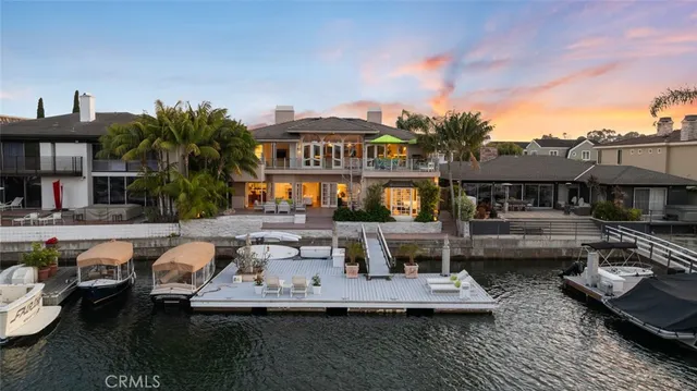 a bedroom with a bed and a lamp on dresser