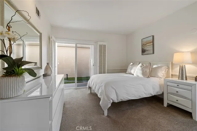 a bedroom with furniture and large window