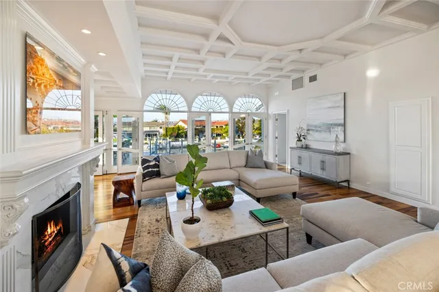 a living room with furniture a fireplace and a large window