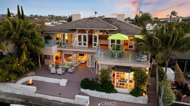 a living room with furniture a flat screen tv and floor to ceiling window