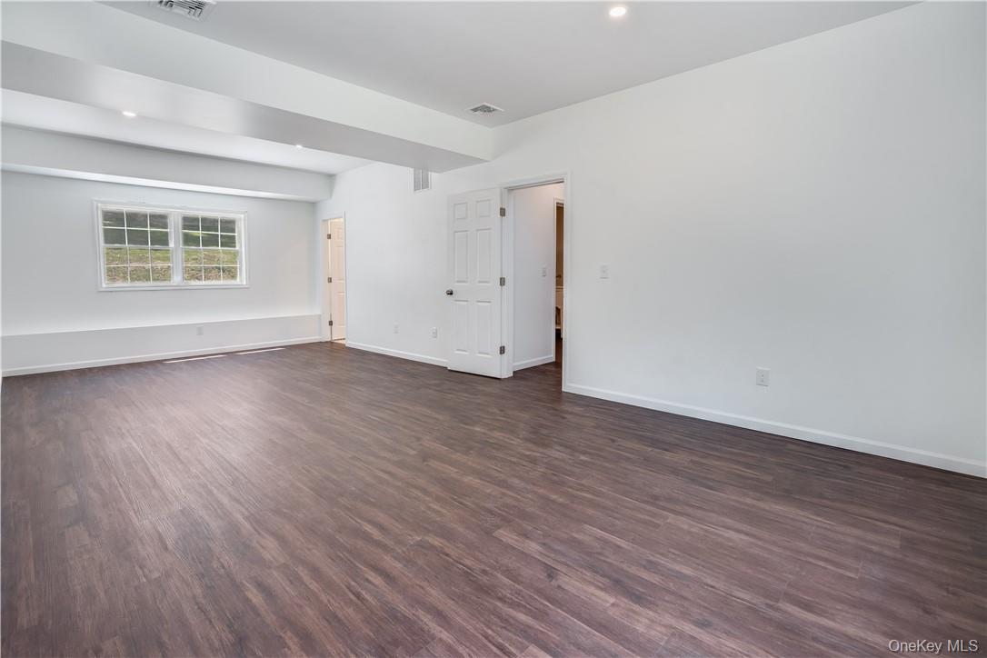 Lot 1 Hillside Lake Road Wappingers Falls, NY 12590 - Photo 16 of 20 an empty room with wooden floor and windows