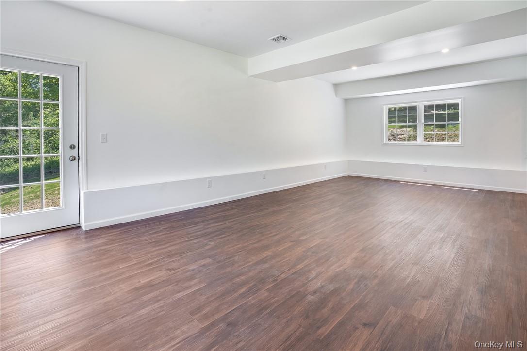Lot 1 Hillside Lake Road Wappingers Falls, NY 12590 - Photo 17 of 20 an empty room with wooden floor and windows