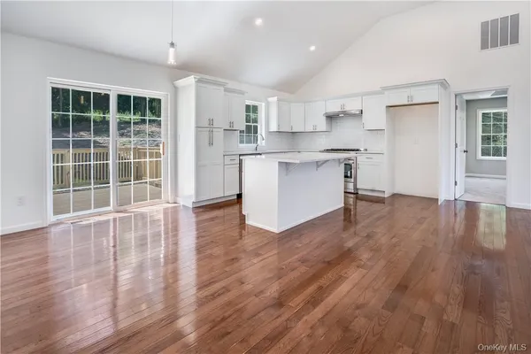 a view of kitchen with wooden floor and electronic appliances