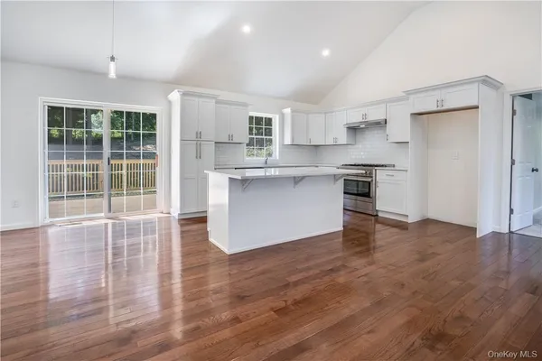 a view of kitchen with granite countertop cabinets and wooden floor