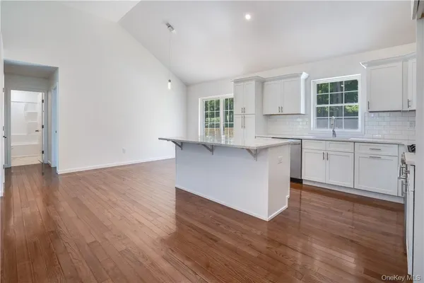 a view of cabinets a wooden floor and windows in a room