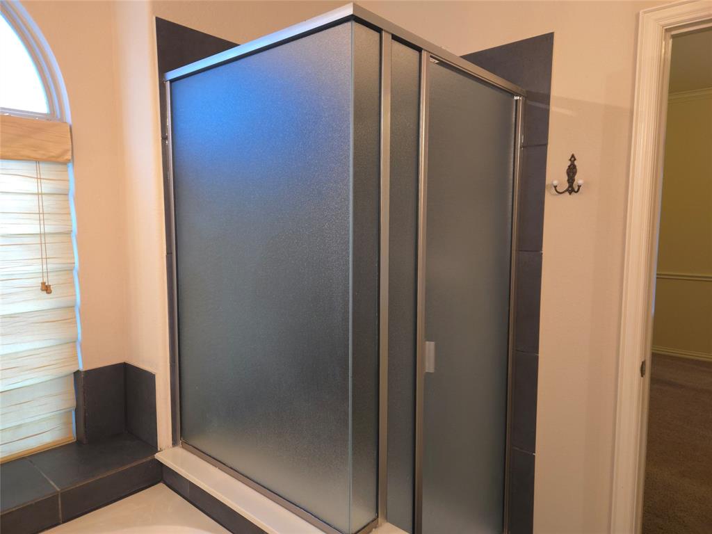 9316 Turtle Pass Fort Worth, TX 76177 - Photo 26 of 38 a bathroom with a glass shower door