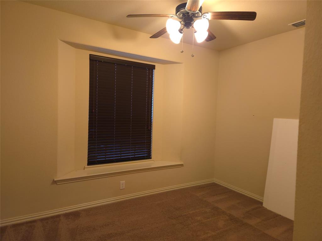 9316 Turtle Pass Fort Worth, TX 76177 - Photo 5 of 38 an empty room with a fan & a window