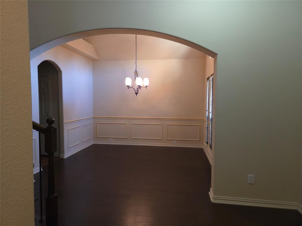 9316 Turtle Pass Fort Worth, TX 76177 - Photo 8 of 38 an empty room with wooden floor and chandelier