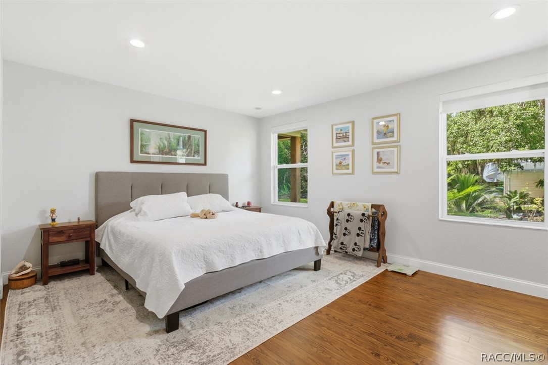 4099 West Ridge Court Dunnellon, FL 34433 - Photo 27 of 49 Spacious master suite with long wall of closets and private entrance to master bath. More baseboards. recessed lighting and Pine floors. Extra newer windows for bright lights and natures view.