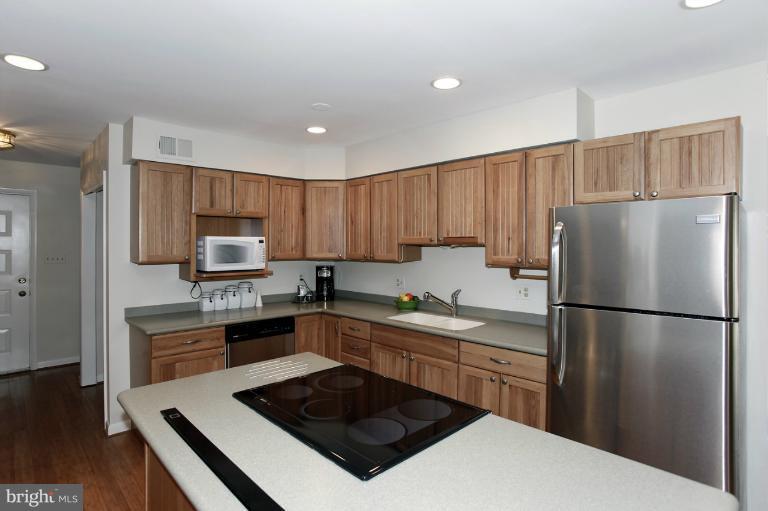 2252 Cedar Cove Court Reston, VA 20191 - Photo 3 of 26 a kitchen with a refrigerator a stove top oven a sink and cabinets