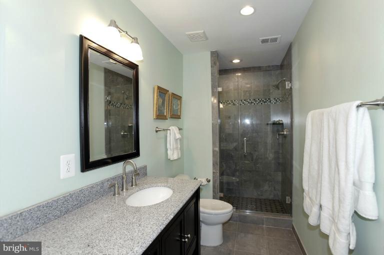 2252 Cedar Cove Court Reston, VA 20191 - Photo 8 of 26 a bathroom with a granite countertop sink toilet and shower