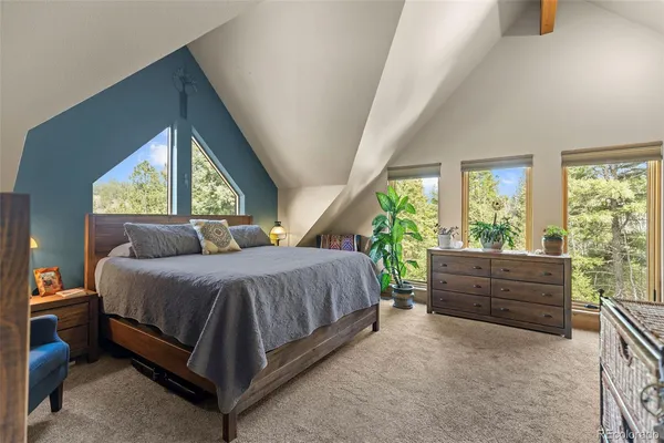 a bed sitting in a bedroom next to a window