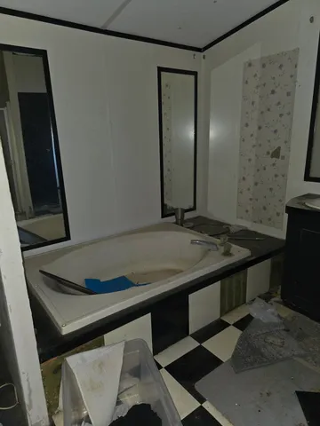 a view of a refrigerator a sink and cabinets