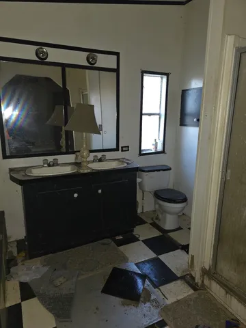 a kitchen with a sink and a mirror