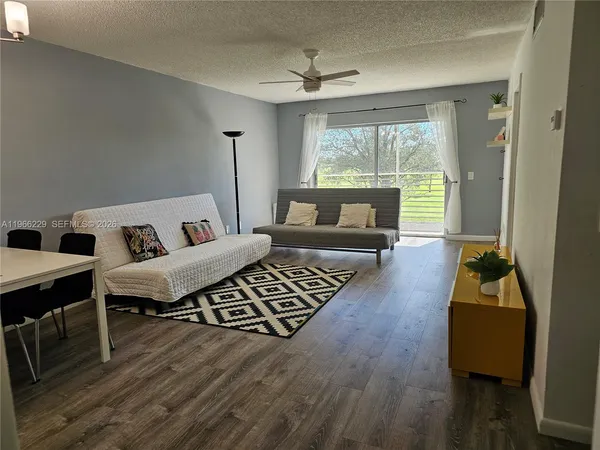 a living room with furniture and a large window