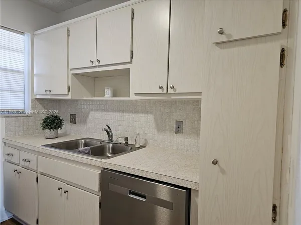 a kitchen with a sink and cabinets