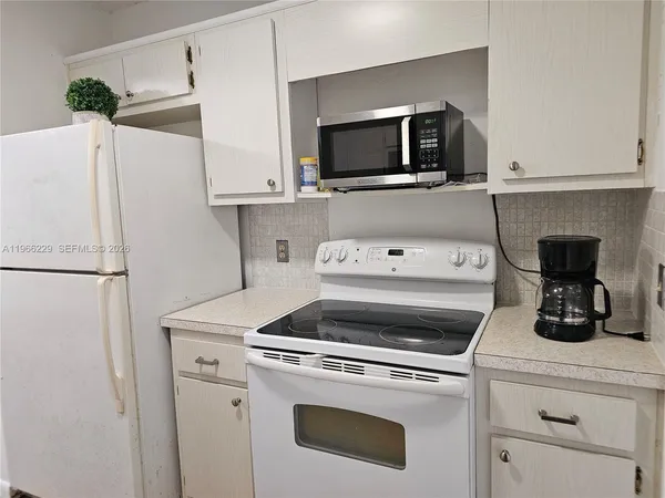 a kitchen with a stove and a refrigerator