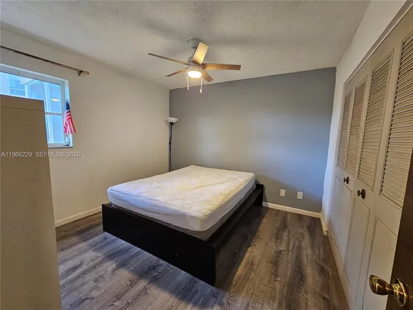 a bedroom with a bed and a mirror