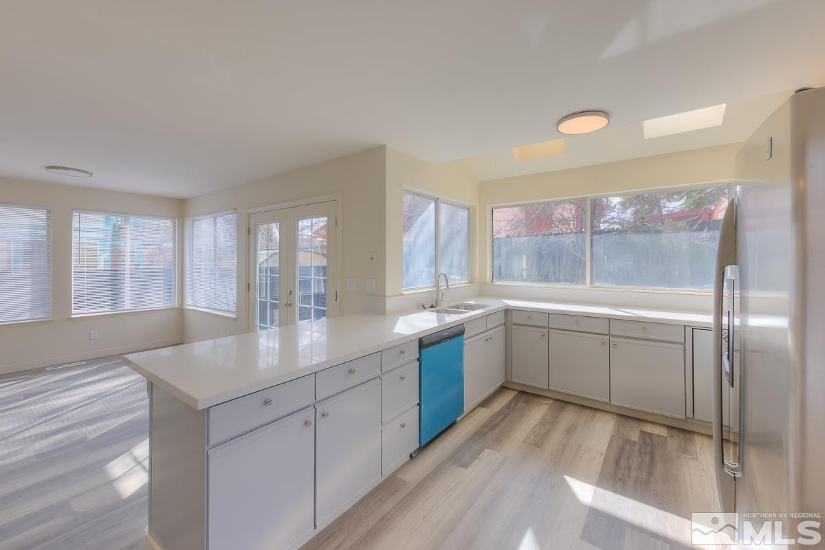 7196 Indigo Circle Reno, NV 89506 - Photo 11 of 33 a kitchen with sink cabinets and chandelier