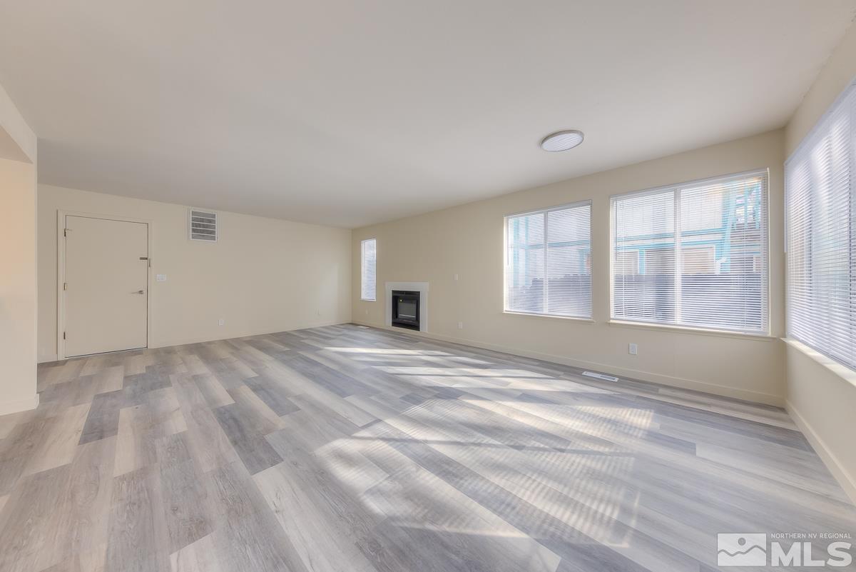 7196 Indigo Circle Reno, NV 89506 - Photo 15 of 33 a view of empty room with wooden floor and fan