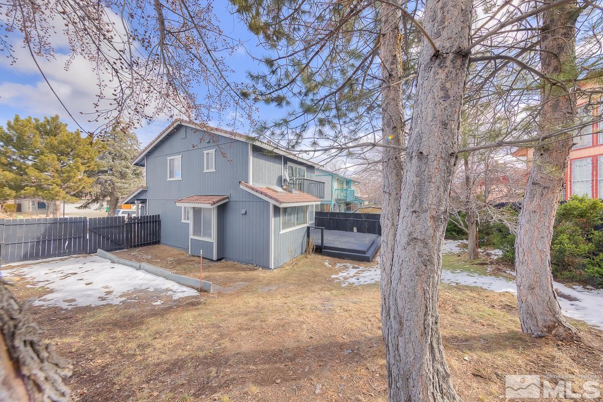 7196 Indigo Circle Reno, NV 89506 - Photo 17 of 33 a view of house with yard and trees in the background
