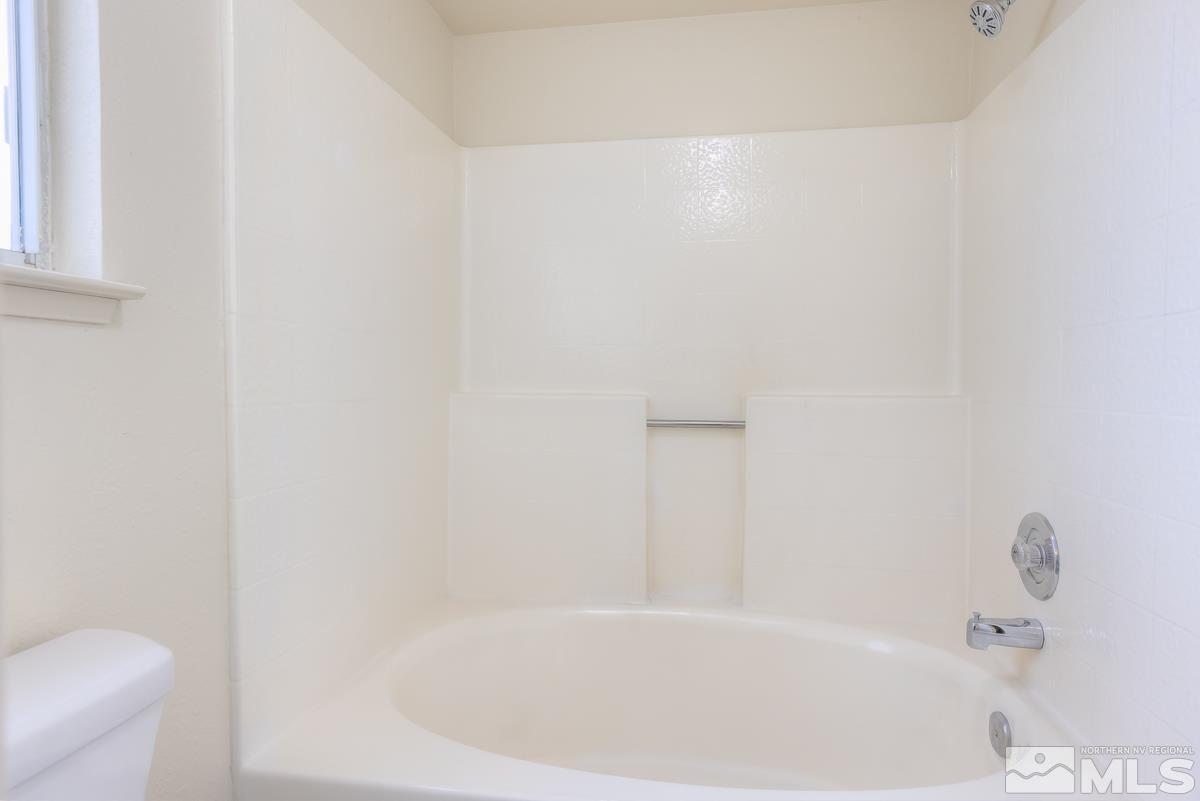 7196 Indigo Circle Reno, NV 89506 - Photo 22 of 33 a white bath tub sitting next to a white toilet